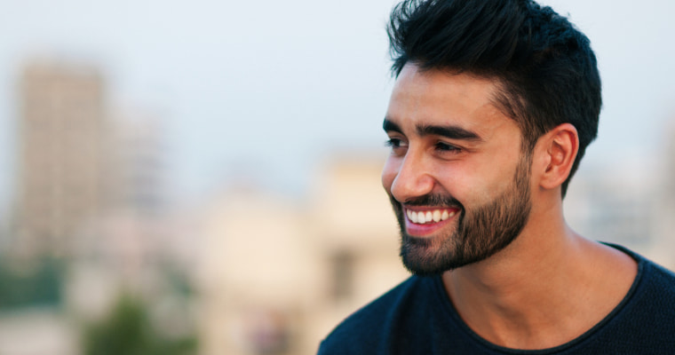 A bearded man smiling