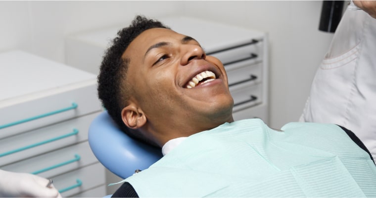 A man smiling in the dentist's chair