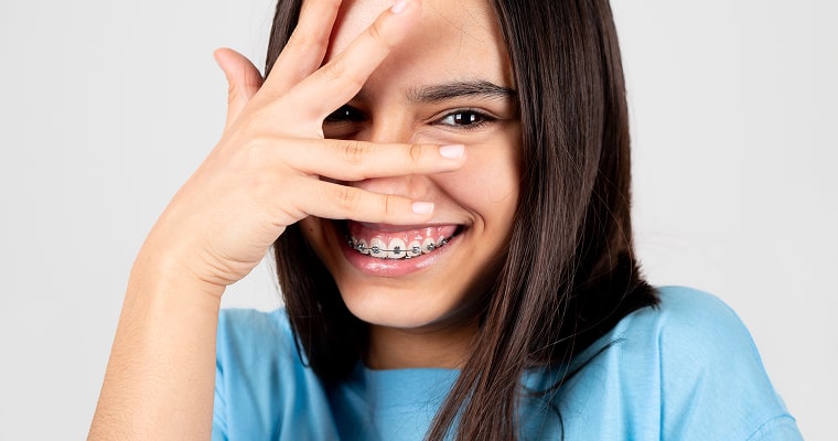 A woman in braces smiling